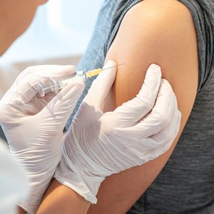 A horizontal view of female doctor vaccinating a female patient
